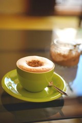 Cappuchino coffee in a green coffee cup