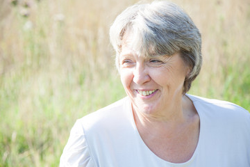 Old age woman smiling white being outside