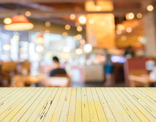 Empty wood table and Coffee shop blur background with bokeh imag