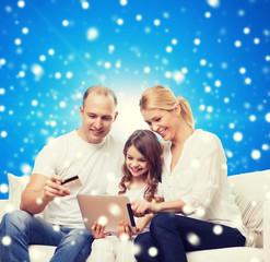 happy family with tablet pc and credit card