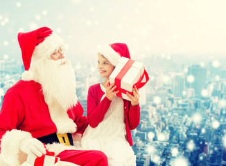 smiling little girl with santa claus and gifts