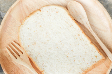 Sliced of whole wheat bread on wooden plate