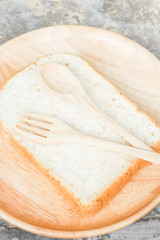 Sliced of whole wheat bread on wooden plate