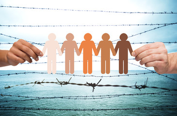 hands holding people pictogram over barb wire