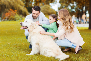 Fototapeta premium happy family with labrador retriever dog in park