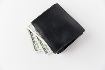 close up of dollar money in black wallet on table