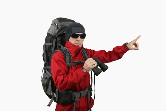 traveler with backpack red jacket with binoculars in hand on a white background specifies a finger into the distance