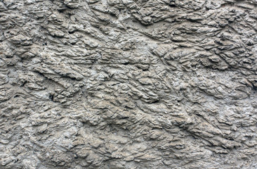 Rough gray plaster wall texture.