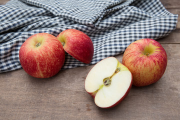 Still life with Red Apples and cloth on a wooden floor.