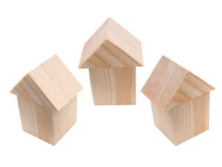 Three houses of wooden building blocks