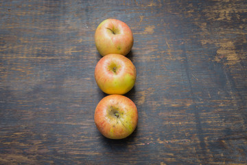 Red apples isolated on a wood background 
