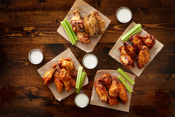 to pdown view of chicken wing party platter made to share with four different flavors and ranch dipping sauce