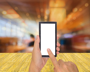 male hand is holding a modern touch screen phone and Coffee shop