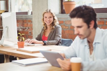 Portrait of young businesswoman working on computer 