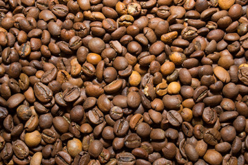 A scattering of coffee beans, close up.