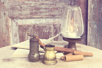 Books, cinnamon, candlestick and turk on a wooden vintage table