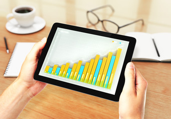 Man holding tablet with business chart