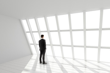 Fototapeta premium Businessman in the white loft interior