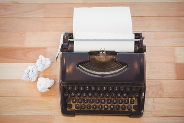 Typewriter with paper on table in office