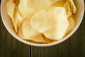 potato chips on wood - soft focus with vintage film filter