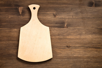Empty cutting board on a wooden background
