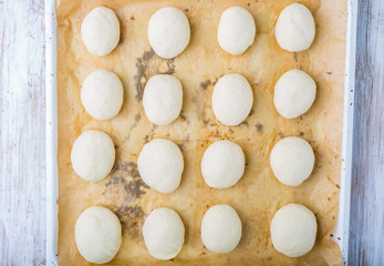 Hand made bread dough cut and formed into bread rolls