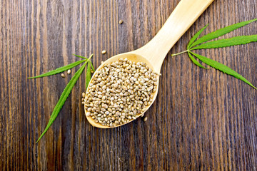 Hemp grain in spoon on board