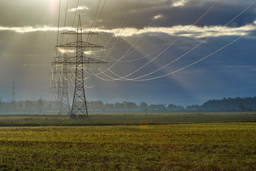 Awesome Landscape picture shows transmission towers, with reflecting cables and great backlight