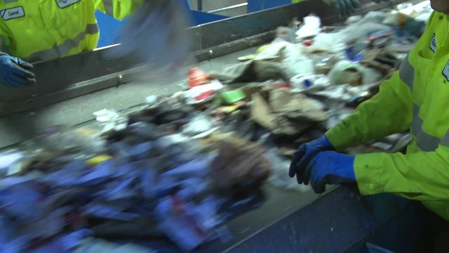 Trash workers on a conveyor