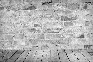 Room with a brick wall and wooden floor.