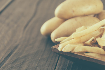 french fries on wood background - soft focus with vintage film f