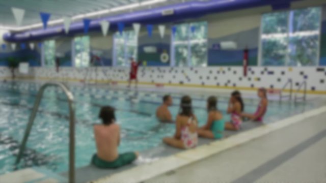 Few people swimming in indoor swimming pool