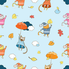 Autumn vector seamless pattern with cartoon cats, umbrellas and leaves on a blue background.