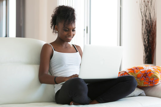 African American student girl using a laptop computer - black pe