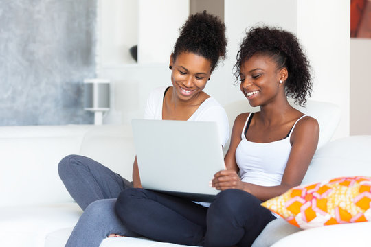 African American student girls using a laptop computer - black p
