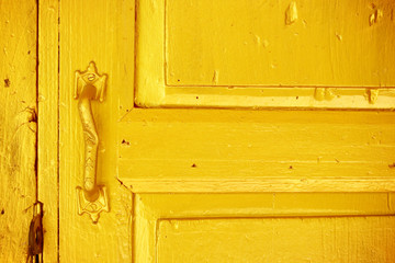 Vintage image of ancient golden door Handle on a wooden door.
