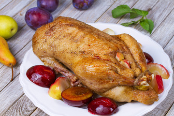 Roast duck with plums and apples