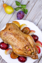 Roast duck with plums and apples