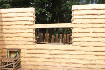 House wall with a heater layer put from a fresh pine bar outdoor