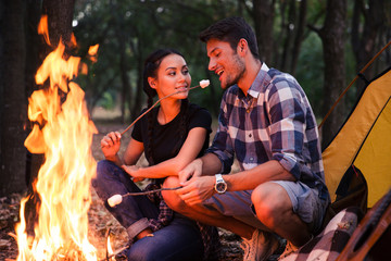 Couple fried sausages on bonfire