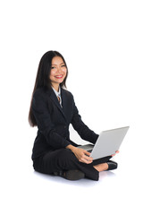 asian chinese female sitting and using laptop