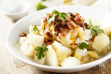 Potato salad with apples, fried onion and ham