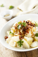 Potato salad with apples, fried onion and ham