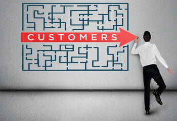 Business man thinking Customers word maze solution
