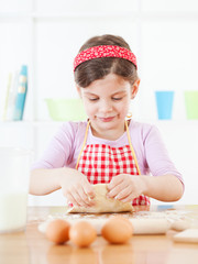 Little girl making the dough