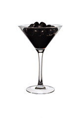 Black olives and juice in a transparent glass close-up. Full glass of juicy black olives in juice on a white background.