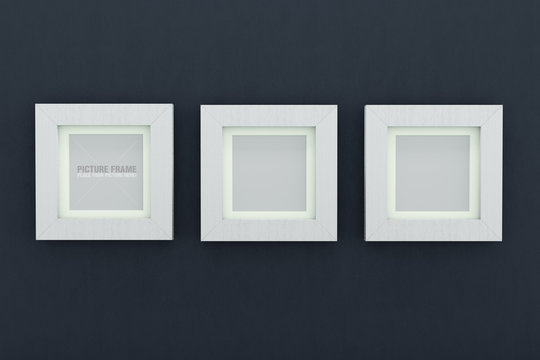 Square white wooden picture frames over navy blue wall