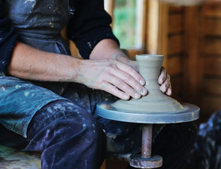 Hands of an artisan working on a potter's wheel
