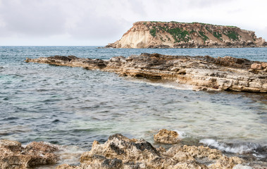 Fototapeta na wymiar Rocky Seascape with the island of geronisos
