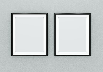 Two black picture frames over light grey wall